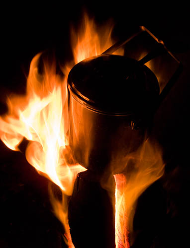 A billy can on top of the fire log. - Ice Raven - Sub Zero Adventure - Copyright Gary Waidson, All rights reserved.